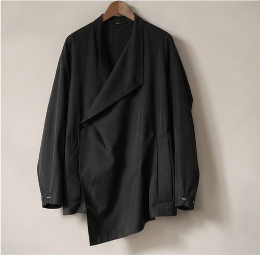 Black asymmetric jacket on wooden hanger